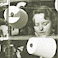 Image: an operative tending a beaming machine at Lily Mills, Shaw in the 1950s